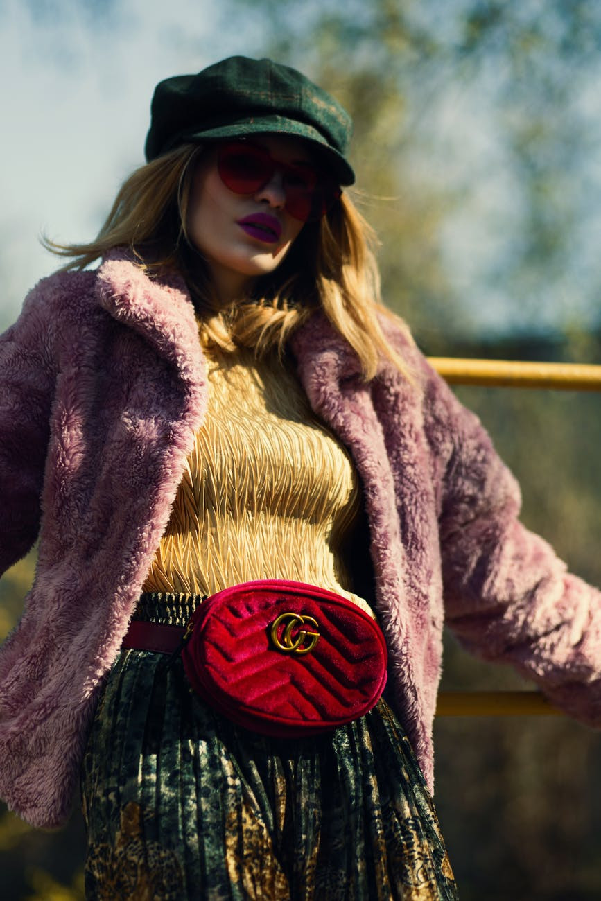 Woman wearing a fur coat and fanny pack