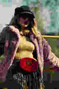 Woman wearing a fur coat and fanny pack