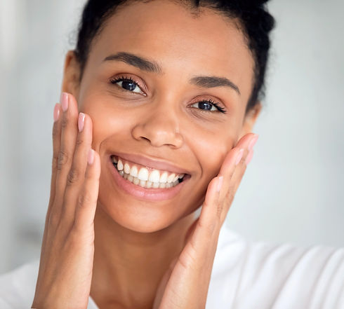 Close up face pretty African woman touches her perfect flawless skin_edited.jpg