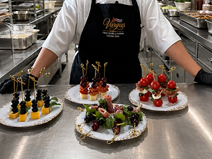 Dainelys preparing a fresh buffet display for a catered event