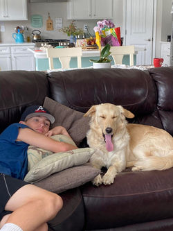 Bobbie's son, Cooper, lounging with Whiskey