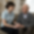 A man and a woman holding hands on sofa _ Thrive Homecare.png