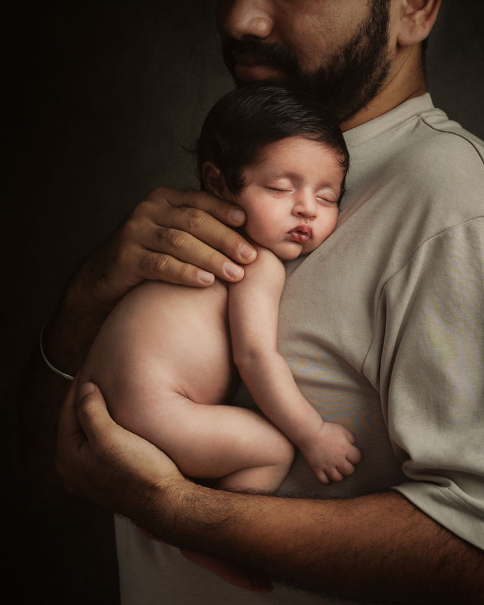Newborn portrait with Parent, captured in a fine art style by Aagam Photography in Bengaluru.
