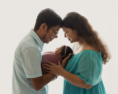 Emotional family moment with newborn, mother, and father