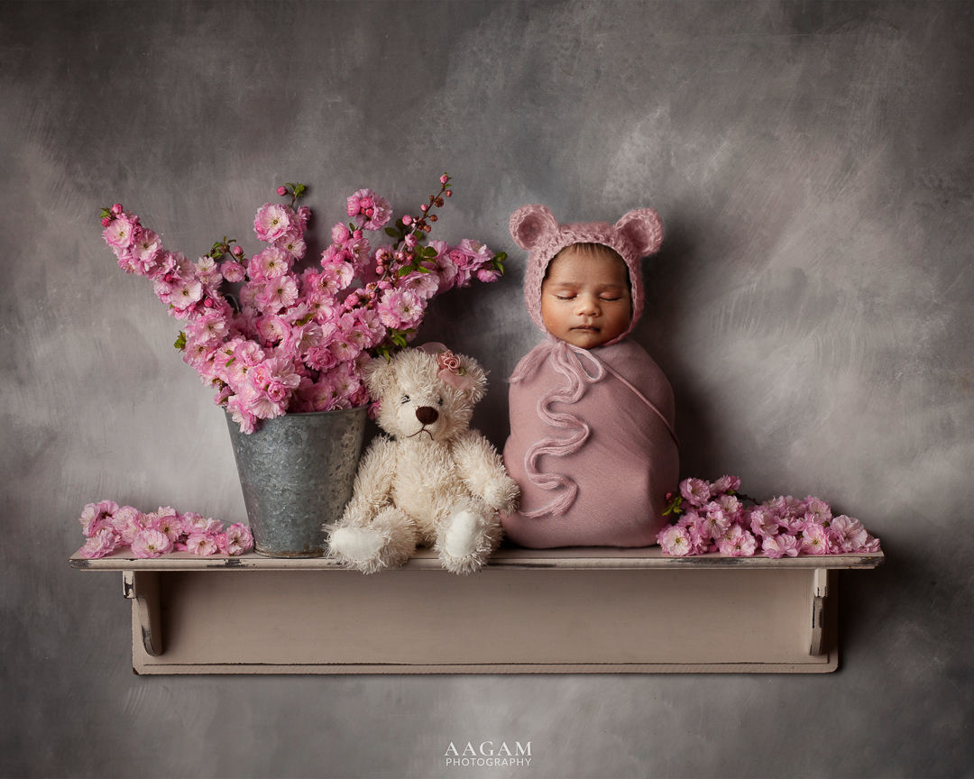 Newborn baby pictured in a floral setup