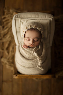 Baby boy in a mini bed prop – creative photography
