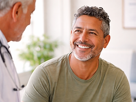 Middle-aged man at a medical consultation discussing health goals related to physical perf