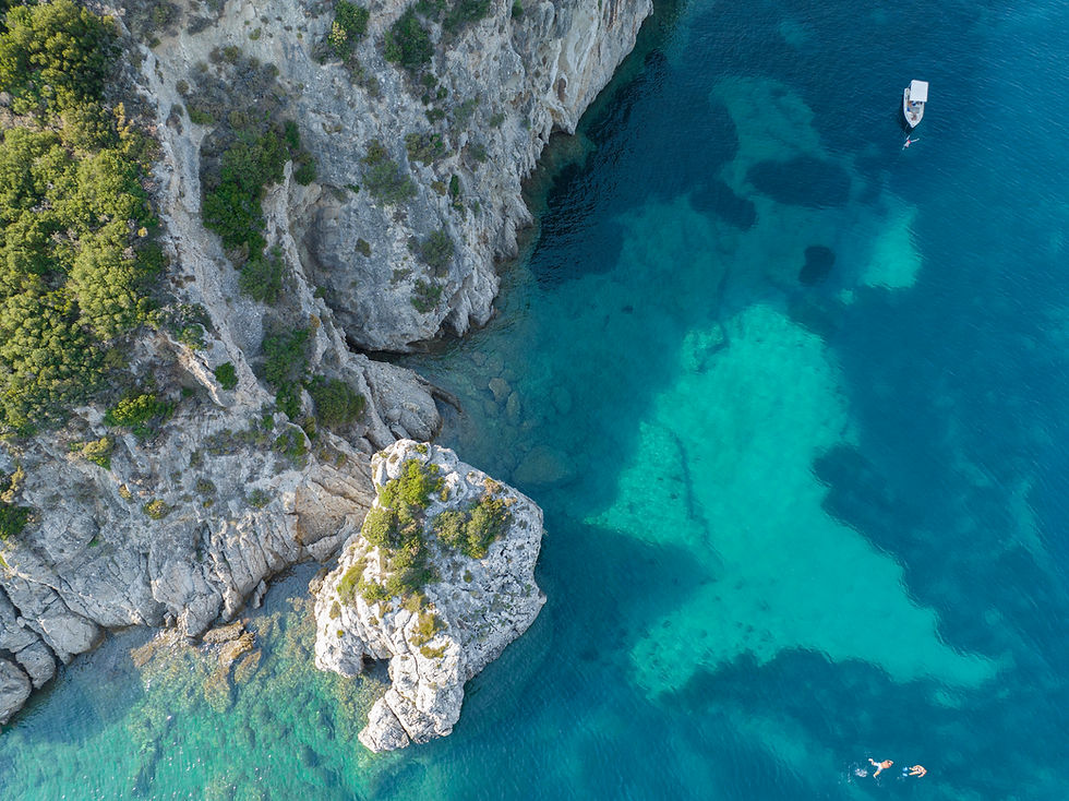 VistaCreate-619256282-stock-photo-aerial-view-boat-moored-coast-island-corfu-crystal-clear