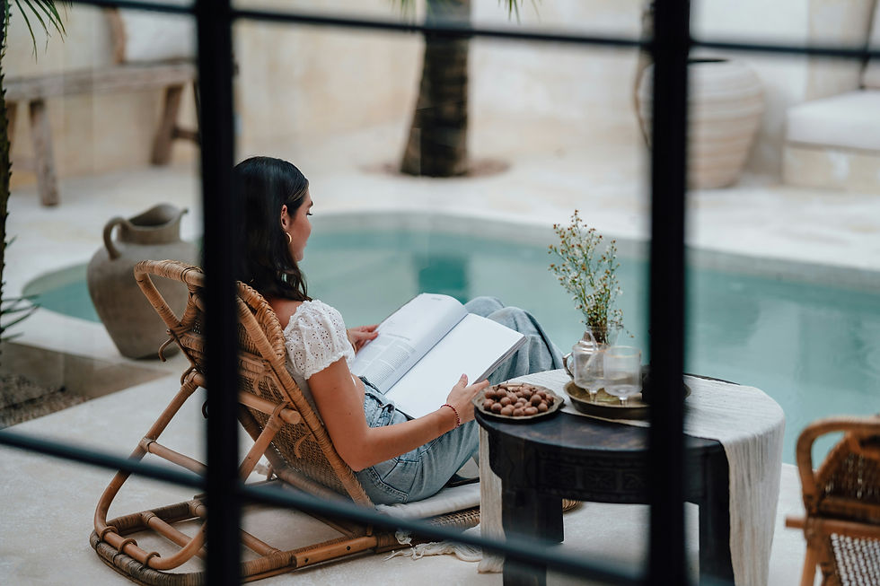 woman sitting by the pool reading in Marbella