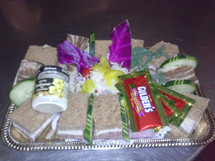 Sandwiches, condiments, and garnish on a silver platter