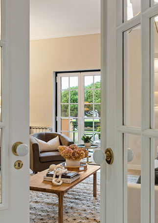 Bright and airy living room with designer finishes and carefully curated accessories in a luxury Beloura apartment