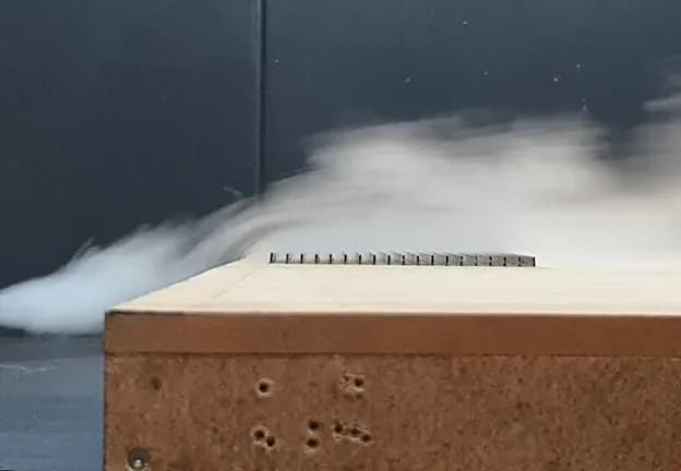 Vertical-solar-panels-in-wind-tunnel-with-smoke-Over-Easy-Solar-1