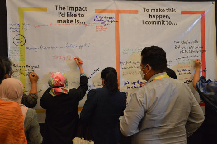 participants writing on a tarpaulin
