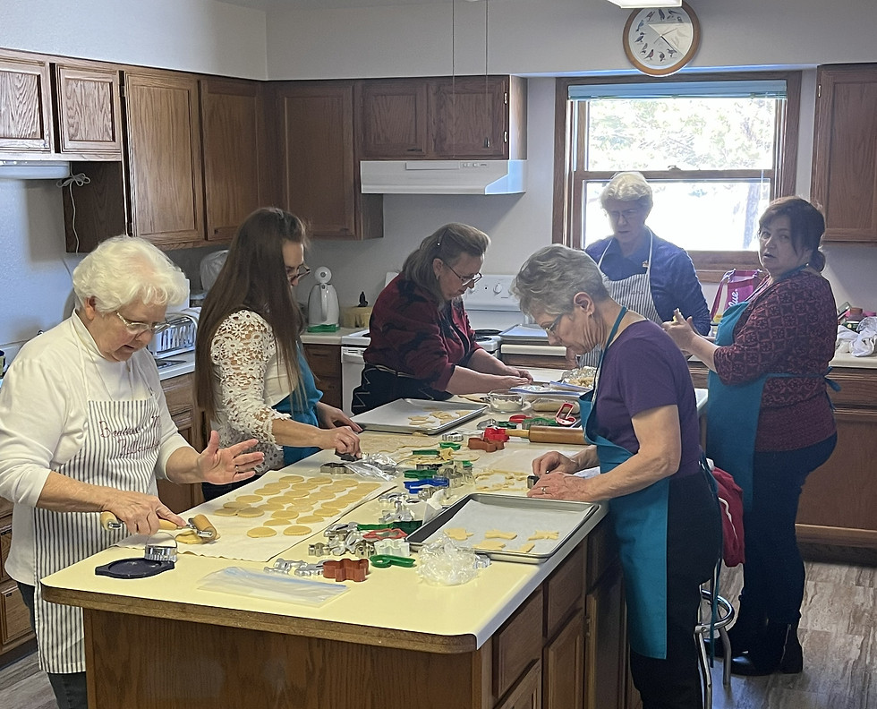 Church members preparing food together in the fellowship kitchen