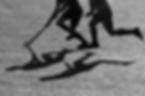 Silhouette. The shadow of a hockey players is running with a hockey stick on a hockey fiel
