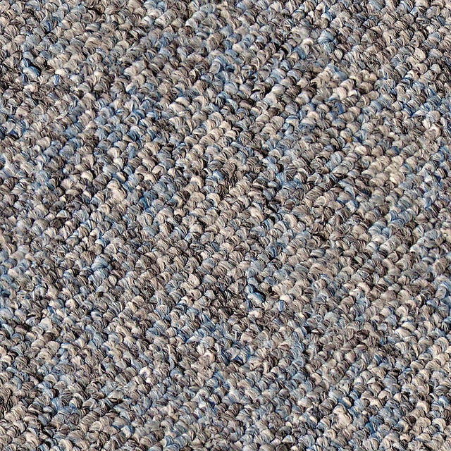 A textured multi-tone carpet featuring a mix of blue and grey fibers, providing a dynamic and stylish appearance.