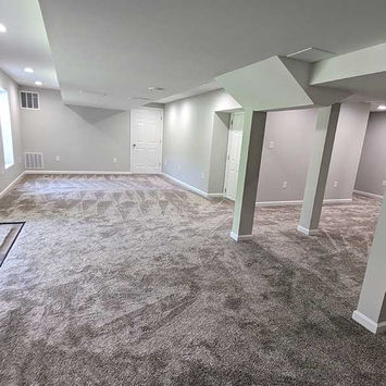 Large basement with plush carpeting and recessed ceiling lights.