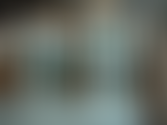 Used vinyl windows stacked in a warehouse at USEDWINDOWSDOORS in Edmonton, ready for pickup.