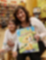 A photo of April with a child at her book signing event.