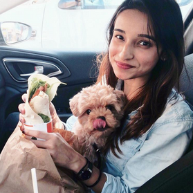 Photograph of illustrator and artist Farhana Hossain, aka Dewmanna with her puppy dog, maltipoo Whisky