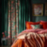 Luxurious bedroom with vibrant floral curtains, rich orange and pink bedding. An ornate framed painting hangs on the dark green wall.
