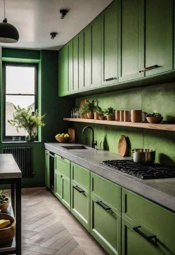 Green kitchen with wooden cabinets, open shelving, and countertop. Fresh herbs and bowls decorate. Natural light from window creates a cozy vibe.
