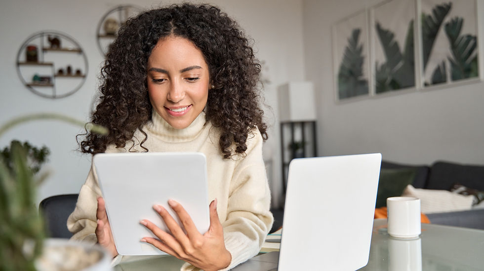 woman business owner working on tablet and laptop
