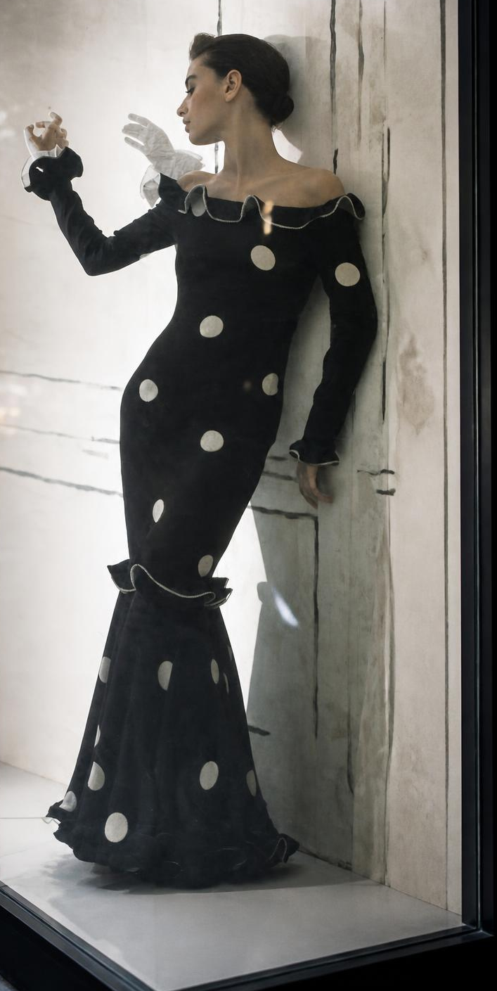 Fashion editorial image of the uploaded full-length figure behind an angled glass display