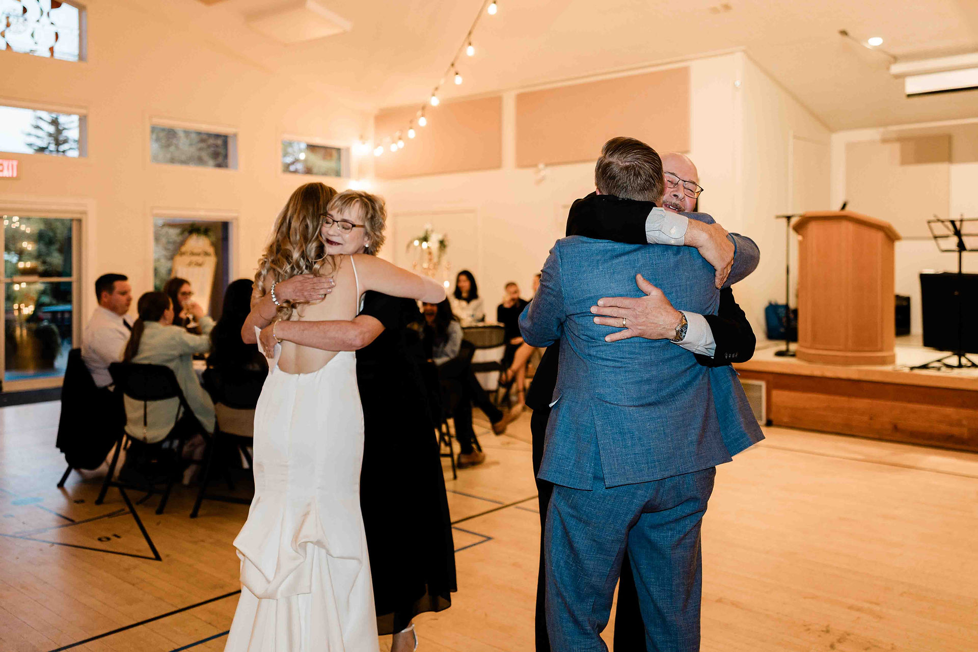 Couple hugging their parents after the speeches 