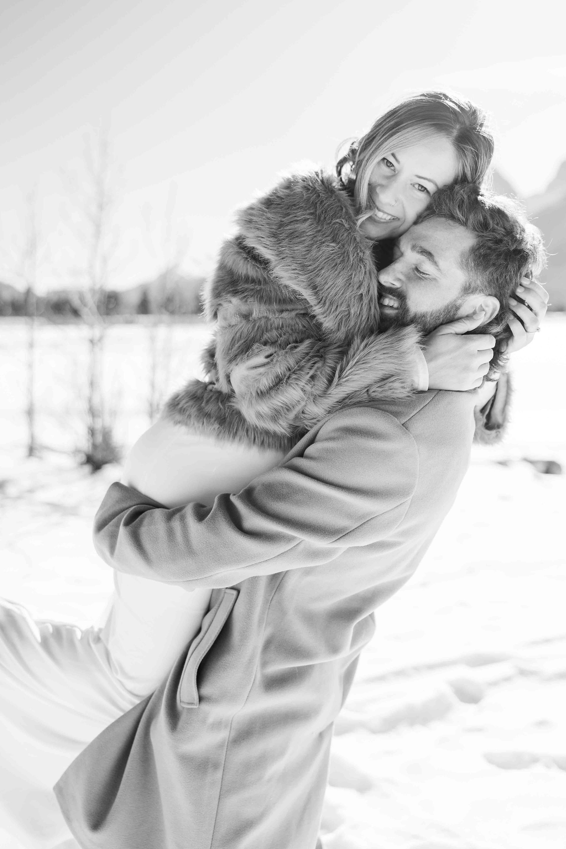 Husband and wife hugging for their bridal portraits in Canmore