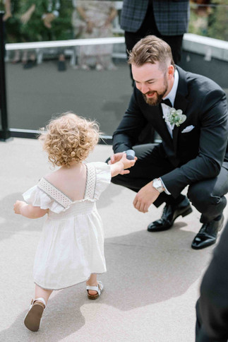 Bride's niece brining wedding rings to the groom