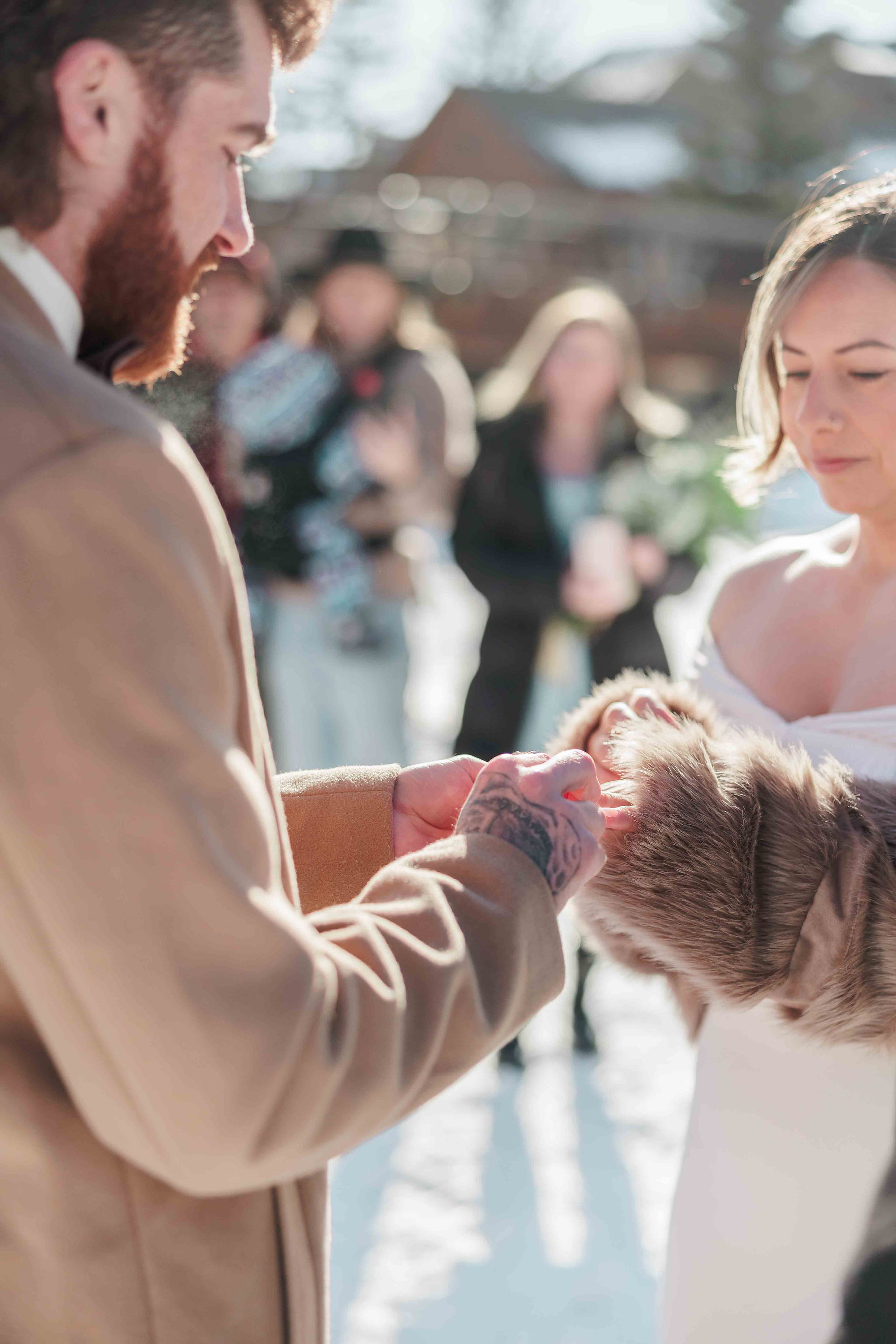 A picture of ring exchange during a wedding in Canmore