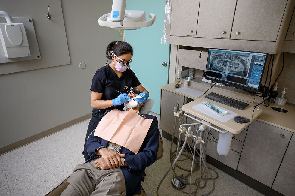 Image of the Dental Hygienist of Mt Pleasant Dental Care Clinic located in Calgary with a patient examing and cleaning their teeth