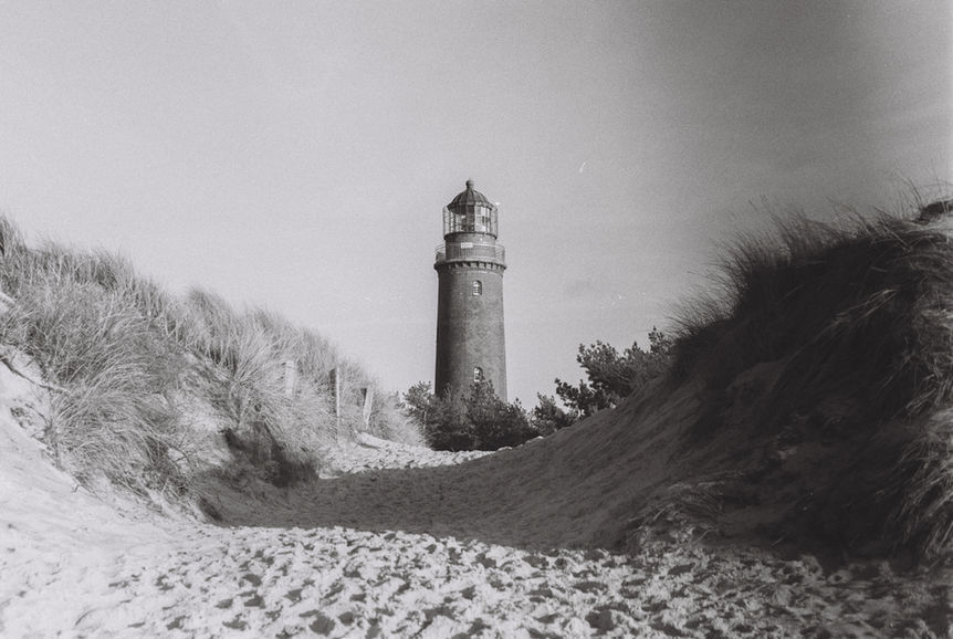 Cinematic street photography by photographer Adam Kaiser-Lynch. Lighthouse in Germany on black and white film.