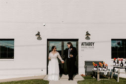 E + A pose in front of the Attaboy Barrel House a modern weddings & events venue in the DMV.