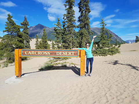 woman standing in front of sign