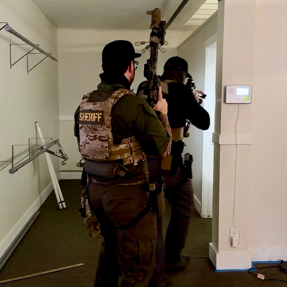 Sheriff officers in tactical gear clearing a hallway