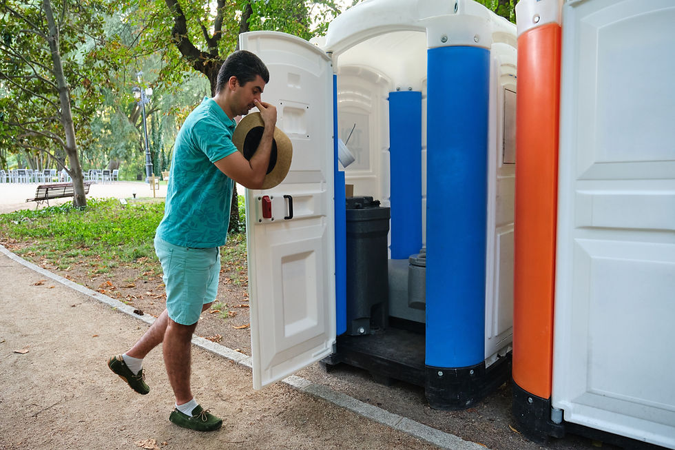 Man plugging his nose because the portable toilets smell