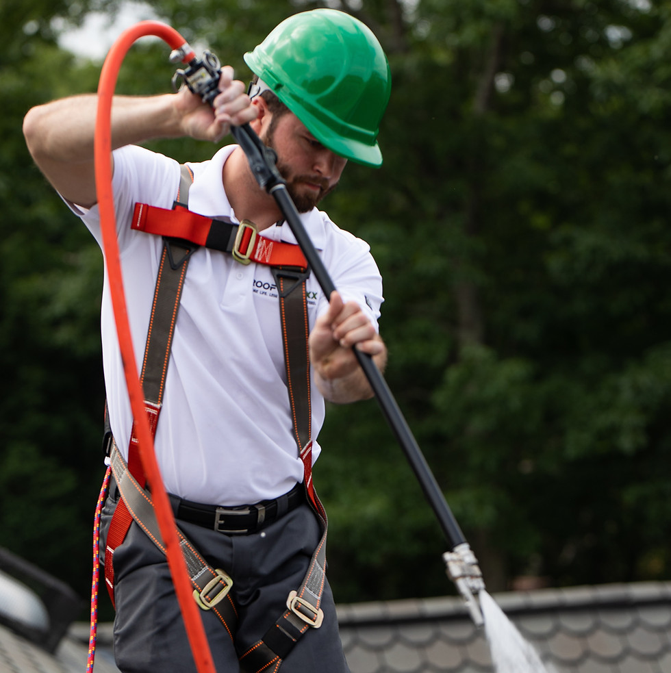 man applying roof maxx treatment