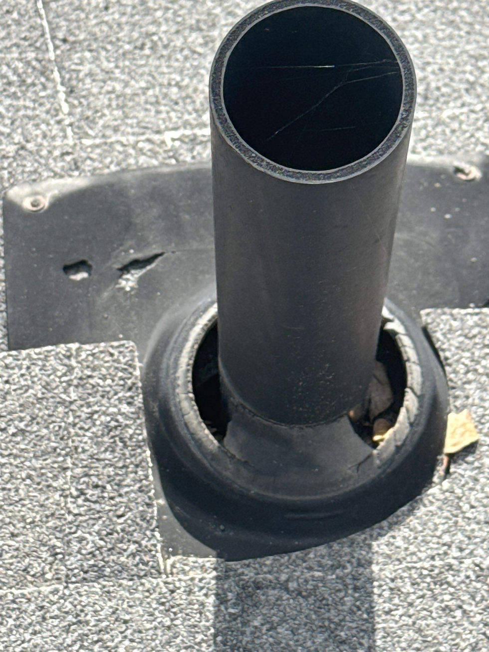 pipe vent with damaged rain collar on a shingle roof