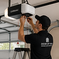 Garage door repair technician servicing commercial door