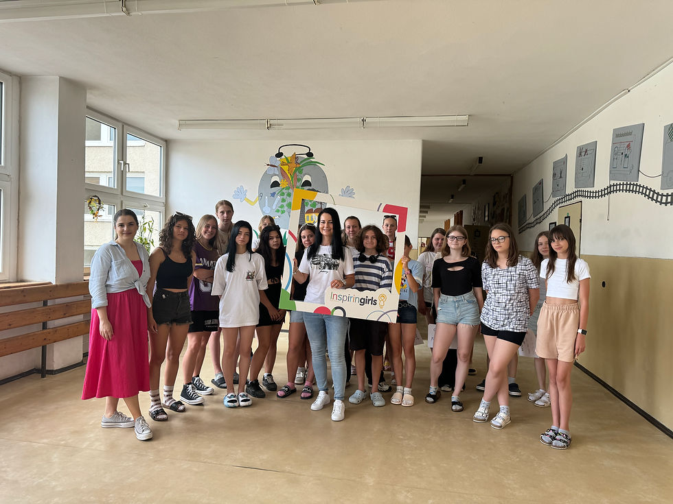 a group of high school girls with a woman speaker after a presentation