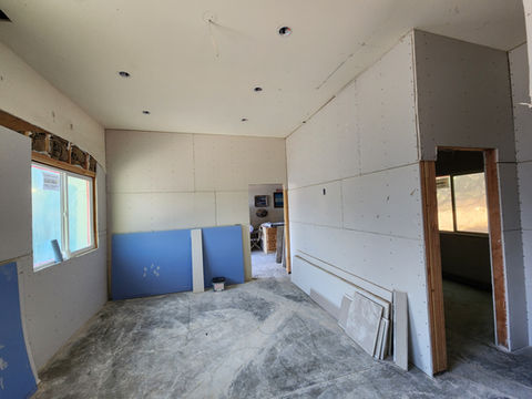 Malibu ADU interior with newly installed drywall and ceiling cutouts, preparing for paint and finish work.