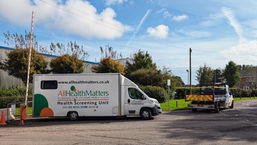 The All Health Matters mobile health screening unit van sits roadside on a sunny day outside Lympne industrial park in Kent.