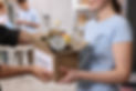 volunteers-holding-donation-box-with-food-products-indoors-closeup.jpg