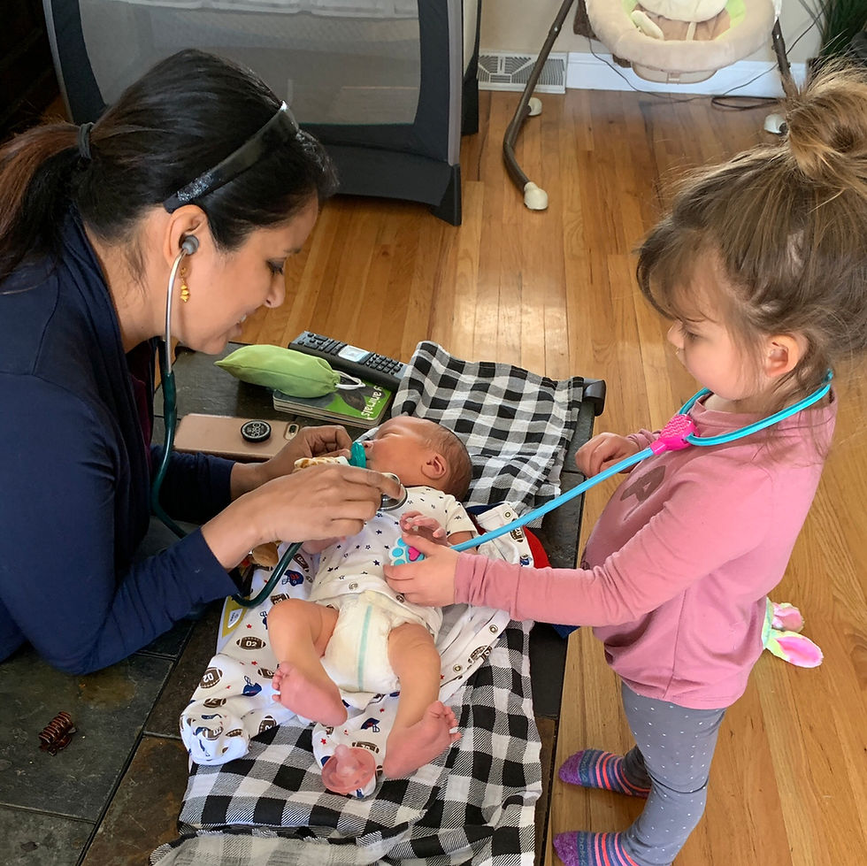 Big sister helping out in a home visit.