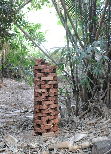 Clay brick earth block sculpture set in a bamboo garden in Bataan, Philippines. Meditative artwork exploring natural building and sustainable construction. Fabian Faylona 2024 / Bataan, Philippines