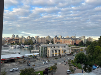 Panoramic view of downtown Victoria, British Columbia, with the Fairmont Empress Hotel prominently visible against a backdrop of modern city buildings. Below, Inner Harbour is dotted with yachts and small boats, while the streets are active with pedestrians, cyclists, and vehicles. The sky is partly cloudy with soft blue patches breaking through.Panoramic view of downtown Victoria, British Columbia, with the Fairmont Empress Hotel prominently visible against a backdrop of modern city buildings. Below, Inner Harbour is dotted with yachts and small boats, while the streets are active with pedestrians, cyclists, and vehicles. The sky is partly cloudy with soft blue patches breaking through.