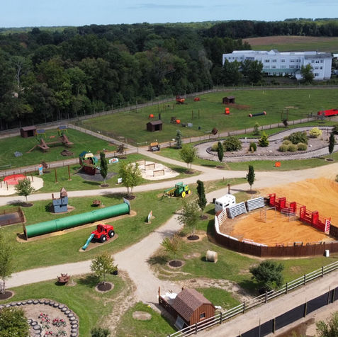 Aerial shot of festival grounds, including attractions and visitors.