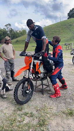 man balancing on bike with trainer
